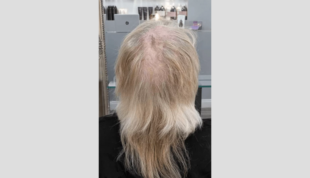 Woman looking at her hair in the mirror
